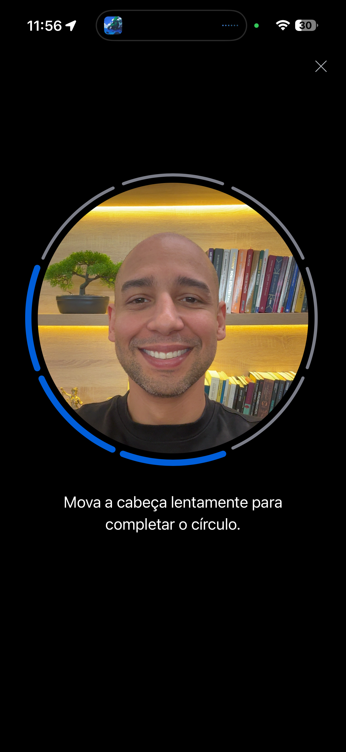 Face capture screen with centred face and blue ring completing